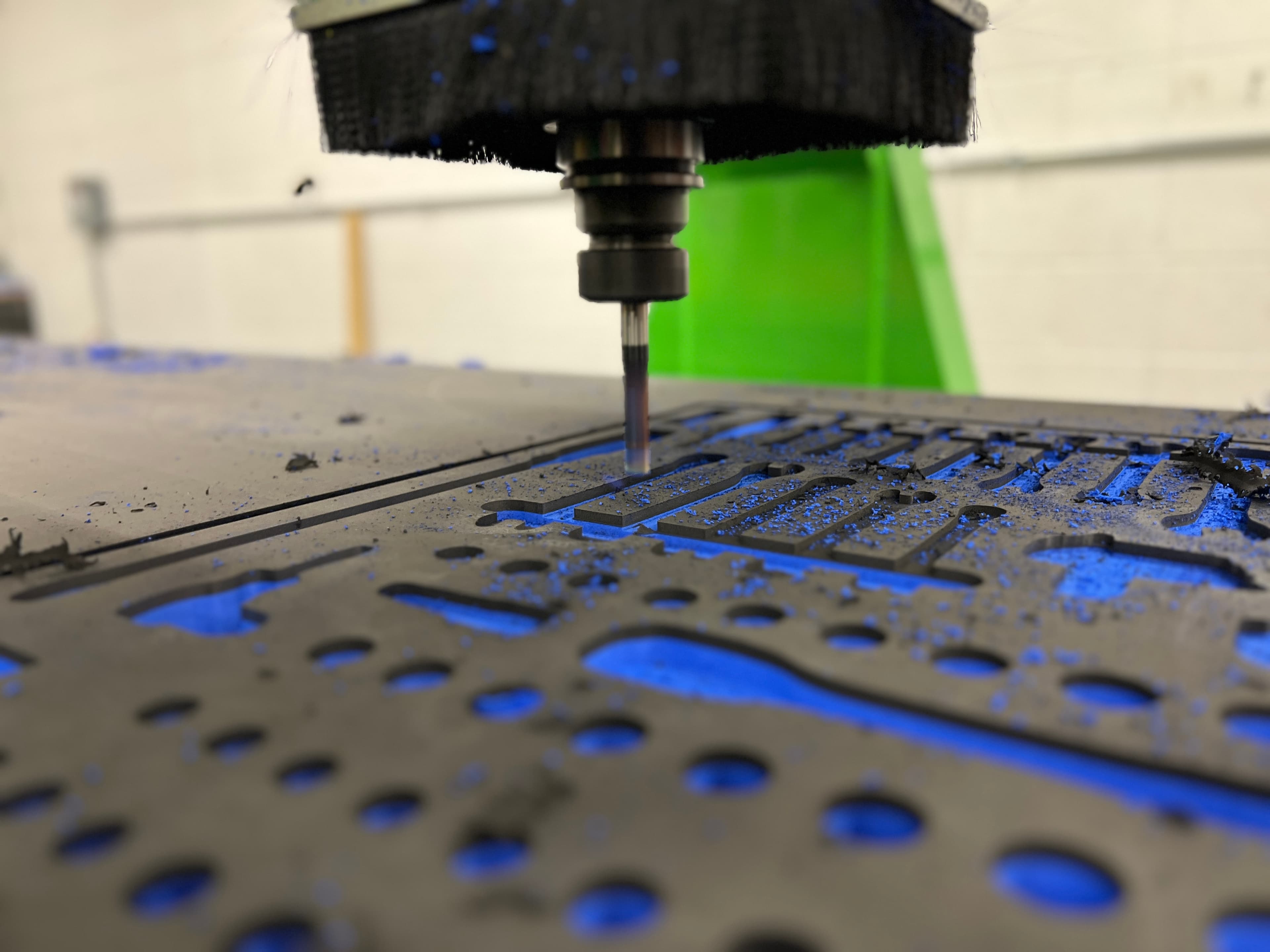 CNC machine cutting tool-shaped pockets into a custom blue foam insert